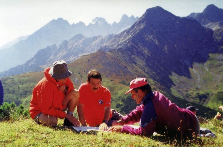 High Tatras, mountain meadow, hikers studying map