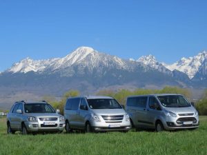 Rajec travel minivans with snowy High Tatras in the background